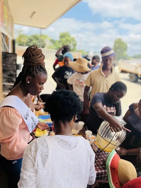 A TruCam volunteer serving meals to community members